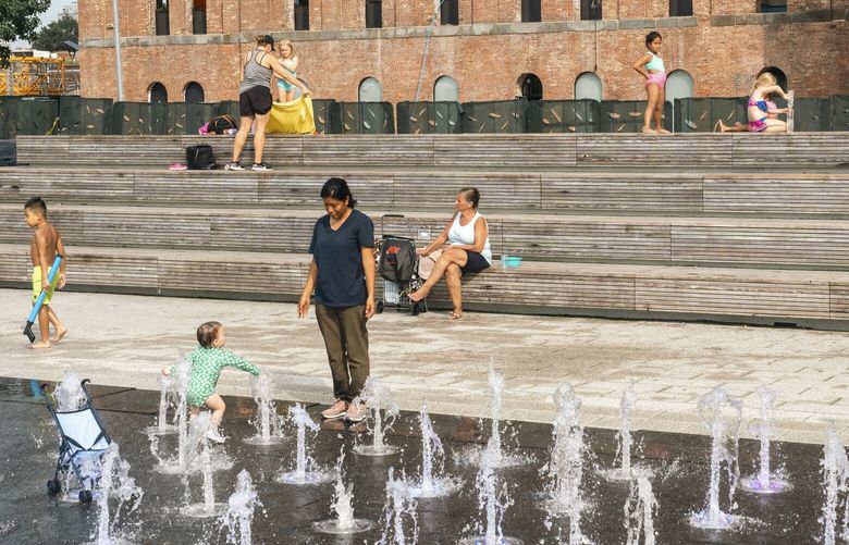 People cool off in fountains at Domino Park in Brooklyn, Sept. 5, 2023. Students are headed back to the classroom, pumpkin-spice coffee is back on the menu and New York City’s public pools are scheduled to close for the season in less than a week, but city residents are encountering some of the most sweltering heat of the year. (Jordan Macy/The New York Times) XNYT0787 XNYT0787