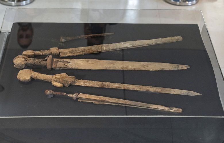 Israeli archaeologists show four Roman-era swords and a javelin head found during a recent excavation in a cave near the Dead Sea, in Jerusalem, Wednesday, Sep. 6, 2023. Archaeologists said the exceptionally preserved artifacts are dated to the 2nd century, when Jewish rebels launched an uprising against the Roman Empire. (AP Photo/Ohad Zwigenberg) XOB101 XOB101