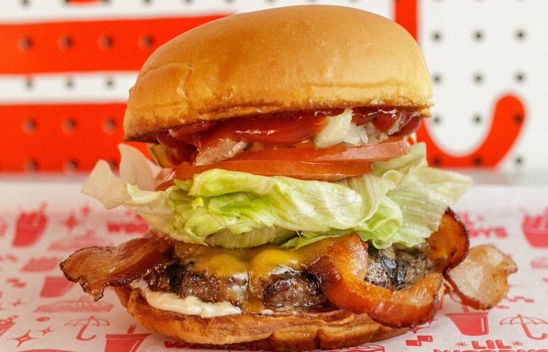 The Big Woody features one-quarter pound beef, bacon, cheddar, chopped onions, diced pickles, tomato slices, lettuce, ketchup and mayo.