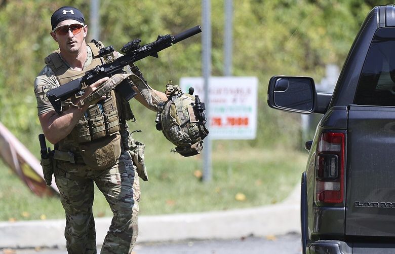 A heavily armed law enforcement officer runs on a potential sighting of Danelo Cavalcante in Pocopson Township, Pa. on Sunday, Sept. 3, 2023. Cavalcante escaped from the Chester County Prison last Thursday. (David Maialetti/The Philadelphia Inquirer via AP) PAPHQ202 PAPHQ202