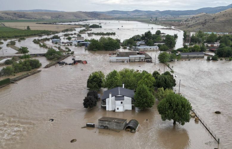Floodwaters cover houses and farms after the country’s record rainstorm in the village of Kastro, near Larissa, Thessaly region, central Greece, Thursday, Sept. 7, 2023. The death toll from severe rainstorms that lashed parts of Greece, Turkey and Bulgaria increased after rescue teams in the three neighboring countries recovered more bodies. (AP Photo/Vaggelis Kousioras) ATH110 ATH110