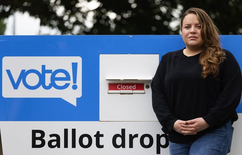 After her ballot was rejected in three successive elections, Kaeleene Escalante Martinez is one of the plaintiffs in a lawsuit challenging the state’s practice of rejecting ballots due to supposed signature mismatches, and has her portrait taken with a ballot dropbox near her Seattle neighborhood, Thursday, Sept. 7, 2023.