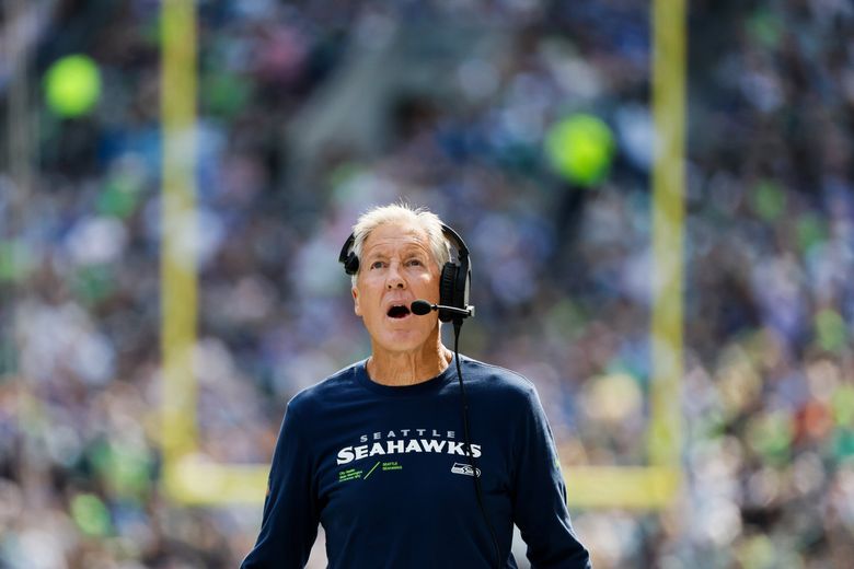 Seattle Seahawks head coach Pete Carroll talks with Detroit Lions