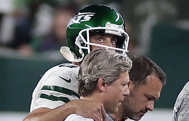 New York Jets quarterback Aaron Rodgers (8) is helped off the field during the first quarter of an NFL football game against the Buffalo Bills, Monday, Sept. 11, 2023, in East Rutherford, N.J. (AP Photo/Adam Hunger) NYJJ117 NYJJ117