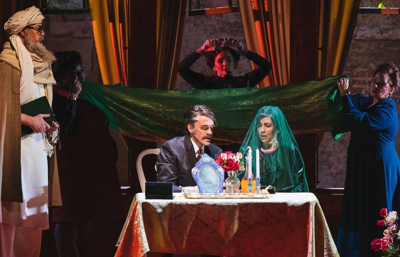 Foreground, from left: Andrew Potter as Mullah, John Moore as Rasheed, Karin Mushegain as Mariam, and Martin Bakari as Jalil. Background, from left: Ibidunni Ojikutu as Wife #2, Sarah Coit as Wife #3, and Sarah Mattox as Wife #1 in A Thousand Splendid Suns at Seattle Opera.