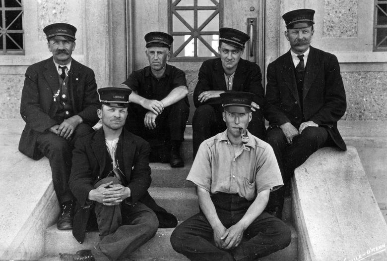 One of the first locking crews sits on the steps on the north side of the administration building in 1917 at the Ballard Locks. Back row: August Falk, George F. Putnum, Alvin D. Wells and Andrew J. Anderson. Front Row: Harrie W. Meacham, Ray Foster. (Courtesy Friends of the Ballard Locks / U.S. Army Corps of Engineers)