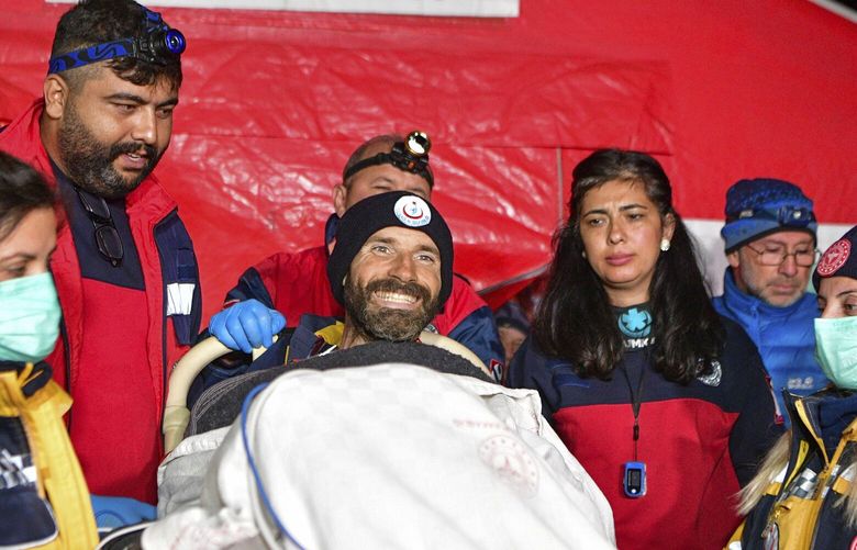 American researcher Mark Dickey, center, talks to journalists after being pulled out of Morca cave near Anamur, south Turkey, on early Tuesday, Sept. 12, 2023, more than a week after he became seriously ill 1,000 meters (more than 3,000 feet) below its entrance. Teams from across Europe had rushed to Morca cave in southern Turkey’s Taurus Mountains to aid Dickey, a 40-year-old experienced caver who became seriously ill on Sept. 2 with stomach bleeding. (Mert Gokhan Koc/Dia Images via AP) FS105 FS105