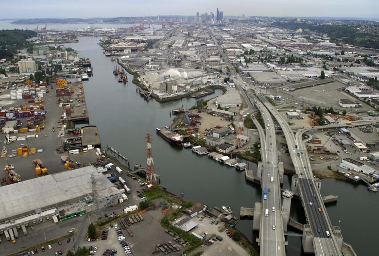 The rechanneled Duwamish River became an industrial and shipping waterway and sewer in the 20th century. The Lower Duwamish Superfund site stretches above and below the First Avenue South Bridge, lower right. (Tom Reese / The Seattle Times, 2004)