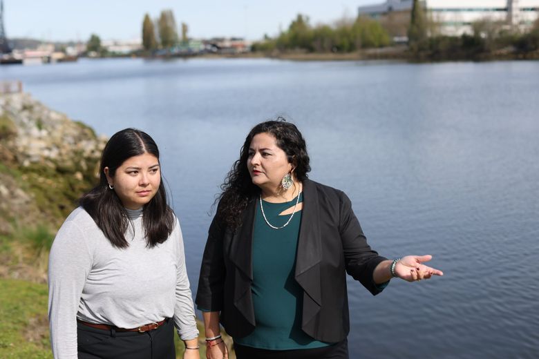 Jamie Hearn, left, Superfund program manager at the Duwamish River Community Coalition, and Paulina López, the group’s executive director, at the Duwamish this year. “The reality is there isn’t a lot of transparency,” López said of the Superfund process. (Karen Ducey / The Seattle Times)