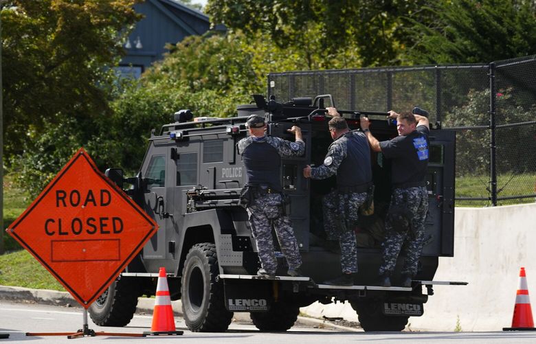 Law enforcement officers ride by a roadblock as the search for escaped convict Danelo Cavalcante continues in Pottstown, Pa., Tuesday, Sept. 12, 2023. (AP Photo/Matt Rourke) PAMR122 PAMR122