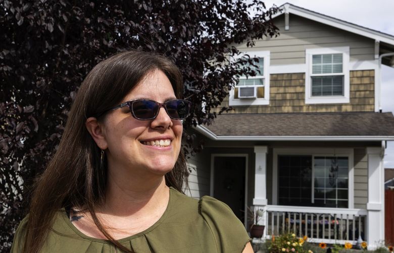 Alicia Allen with her new home in Tacoma, near Spanaway, Monday, Sept. 11, 2023. Allen got a better deal on her loan by buying in Pierce County.
