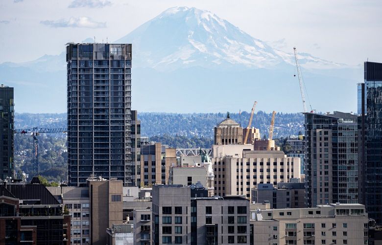 Mount Rainier looms in this skyline view of Seattle looking south from the Ren Luxury Apartments Wednesday, Sept. 13, 2023.