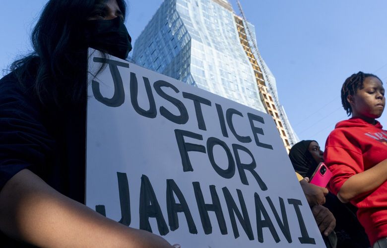 A protester holds a sign calling for justice as people protest after body camera footage was released of a Seattle police officer joking about the death of Jaahnavi Kandula, a 23-year-old woman hit and killed in January by officer Kevin Dave in a police cruiser, Thursday, Sept. 14, 2023, in Seattle. (AP Photo/Lindsey Wasson) WALW413 WALW413