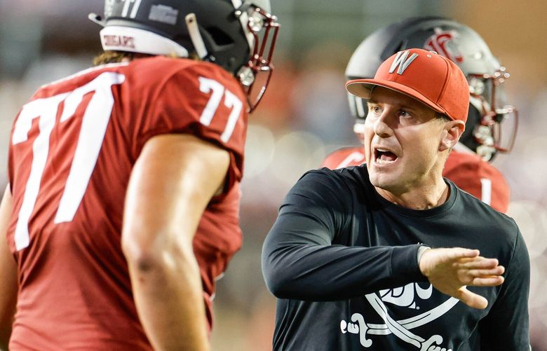 Coach Jake Dickert congratulates offensive lineman Konner Gomness after the Cougars scored with 5:30 remaining to seal the victory over Wisconsin.  The Wisconsin Badgers played the Washington State University Cougars in NCAA Football Saturday, Sept. 9, 2023 at Martin Stadium, in Pullman, WA. 224934