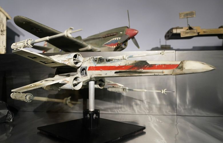 A miniature model called “Red Leader”, a X-wing starfighter from the 1977 film, Star War, Episode IV, A New Hope, sits on display at Heritage Auctions, Thursday, Aug. 30, 2023, in Irving, Texas. While Greg Jein’s work over nearly half a century making miniature models in Hollywood included such iconic creations as the alien mothership in “Close Encounters of the Third Kind,” he was also a lifelong collector of costumes, props, scripts, artwork and photographs from the shows he loved, including countless rare items from the “Star Trek” and “Star Wars” franchises. Thousands of those items, including those Jein collected and those he created, will be offered up by Heritage Auctions next month in Dallas. (AP Photo/Tony Gutierrez) TXTG118 TXTG118