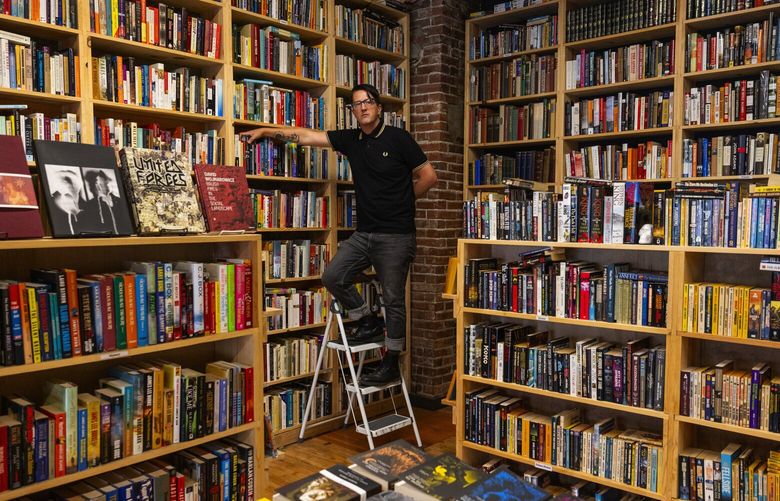 Andrew Larson is the owner of Apparition Books, Wednesday, Sept. 13, 2023, in Renton. Larson says although space is limited he eventually plans having more bookcases added.