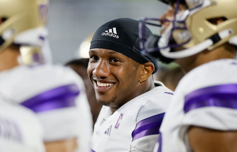 Washington Huskies quarterback Michael Penix Jr. smiles on the sidelines during the fourth quarter against the Michigan State Spartans Saturday, Sept. 16, 2023 in East Lansing, MI. 224978