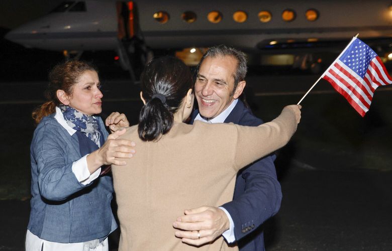 Family members embrace freed American Emad Shargi after he and four fellow detainees were released in a prisoner swap deal between U.S and Iran, as he arrives at Davison Army Airfield, Tuesday, Sept. 19, 2023 at Fort Belvoir, Va. (Jonathan Ernst/Pool via AP) WX303 WX303