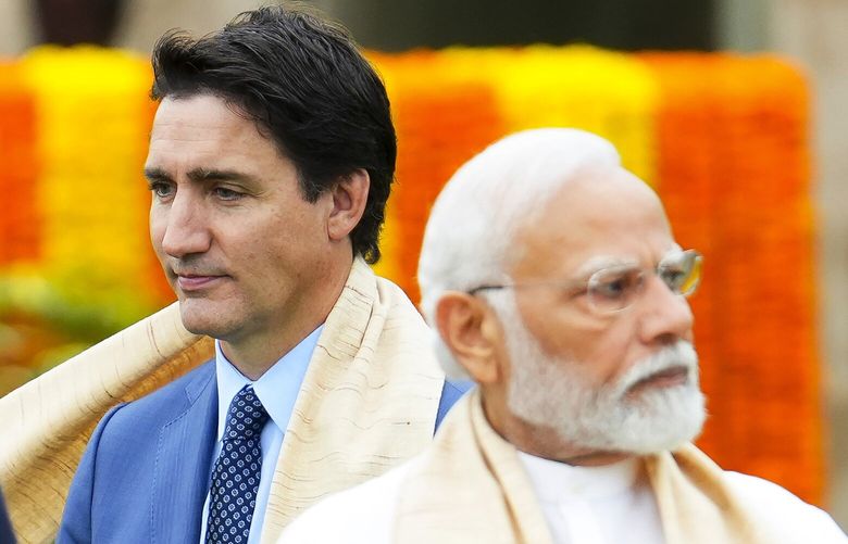 FILE – Canada’s Prime Minister Justin Trudeau, left, walks past Indian Prime Minister Narendra Modi as they take part in a wreath-laying ceremony at Raj Ghat, Mahatma Gandhi’s cremation site, during the G20 Summit in New Delhi, Sunday, Sept. 10, 2023. Trudeau said that Canada wasn’t looking to escalate tensions, but asked India on Tuesday, Sept. 19, to take the killing of a Sikh activist seriously after India called accusations that the Indian government may have been involved absurd.(Sean Kilpatrick/The Canadian Press via AP, File) NY160 NY160