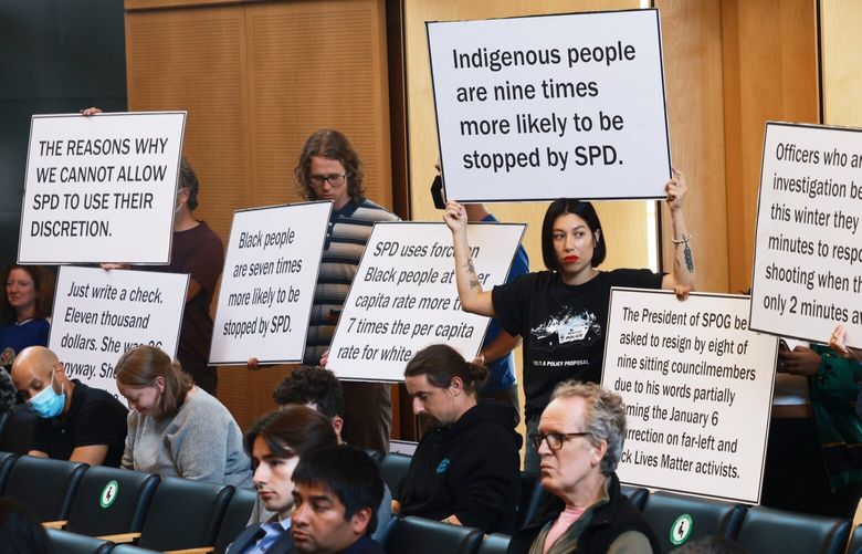 Some commenters lined the back of the council chambers Tuesday with large signs critical of Nelson’s amendments, listing “the reasons why we cannot allow SPD to use their discretion,” naming past examples of SPD conduct including a recently surfaced video of a police union leader joking about the SPD killing of 23-year-old pedestrian Jaahnavi Kandula.
