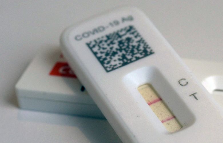 FILE – COVID-19 antigen home tests indicating a positive result are photographed in New York, April 5, 2023. The Biden administration has announced that it is providing $600 million in funding to produce new at-home COVID-19 tests and is restarting a website allowing Americans to again order up to four free tests per household. (AP Photo/Patrick Sison, File) WX110 WX110