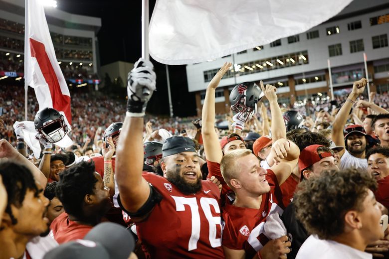 The Cougars celebrate their upset win against No. 19 Wisconsin on Sept. 9 at Martin Stadium.  (Dean Rutz / The Seattle Times)