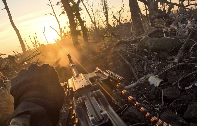 In this image taken from a video released by the 3rd Assault Brigade, a Ukrainian servicemen fires machine gun towards Russian positions near Andriivka, Donetsk region, Ukraine, Aug. 27, 2023. Ukrainian brigade’s two-month battle to fight its way through a charred forest shows the challenges of the country’s counteroffensive in the east and south. (AP Photo) XFD203 XFD203