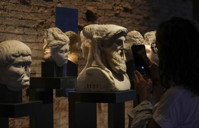 A visitor admires archeological finds inside the newly restored domus Tiberiana, one of the main imperial palaces, during the press preview on Rome’s Palatine Hill, in Rome, Italy, Wednesday, Sept. 20, 2023. The Domus Tiberiana will reopen to the public on Sept. 21. (AP Photo/Gregorio Borgia) XGB109 XGB109