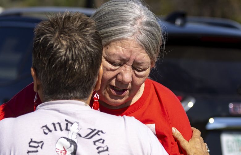 Yolanda Fraser, Kaysera Stops Pretty Places’ grandmother, gets a hug before a dedication ceremony for a billboard in support of the Missing and Murdered Indigenous People movement on Tuesday, Aug. 29, 2023, along I-90 in Hardin, Mont. (AP Photo/Mike Clark) MTMC105 MTMC105