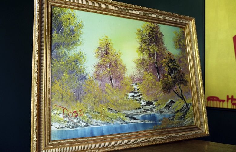 “A Walk in the Woods,” the first painting Bob Ross produced for hic iconic show “The Joy of Painting,” sits on display at the home of Modern Artifact owner Ryan Nelson, Tuesday, Sept. 19, 2023, in Wayzata, Minn. Ross was known for his unpretentious approach to painting on his long-running show, “The Joy of Painting,” but now the painting he completed on his first show in 1983 is for sale for nearly $10 million. Minneapolis gallery owner Ryan Nelson calls it the “rookie card” for Ross. (AP Photo/Mark Vancleave) MNMV201 MNMV201