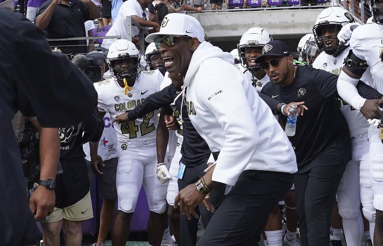 Colorado head coach Deion Sanders runs onto the field with his team for a an NCAA college football game against TCU Saturday, Sept. 2, 2023, in Fort Worth, Texas. (AP Photo/LM Otero) TXMO121 TXMO121