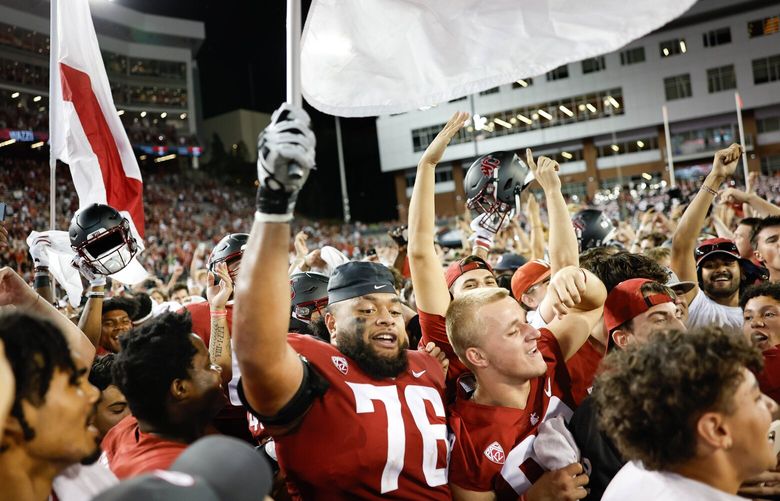 The Cougars celebrate their upset wn of No. 19 Wisconsin.  The Wisconsin Badgers played the Washington State University Cougars in NCAA Football Saturday, Sept. 9, 2023 at Martin Stadium, in Pullman, WA. 224934