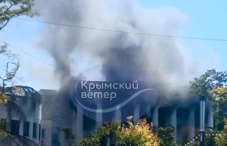 In this photo taken taken from video on Friday, Sept. 22, 2023, smoke rises over the Headquarters of Russia’s Black Sea Fleet in Sevastopol, Crimea. Russia says Ukraine carried out a missile strike on the main headquarters of its Black Sea Fleet and one serviceman is missing. (AP Photo) XEST107 XEST107