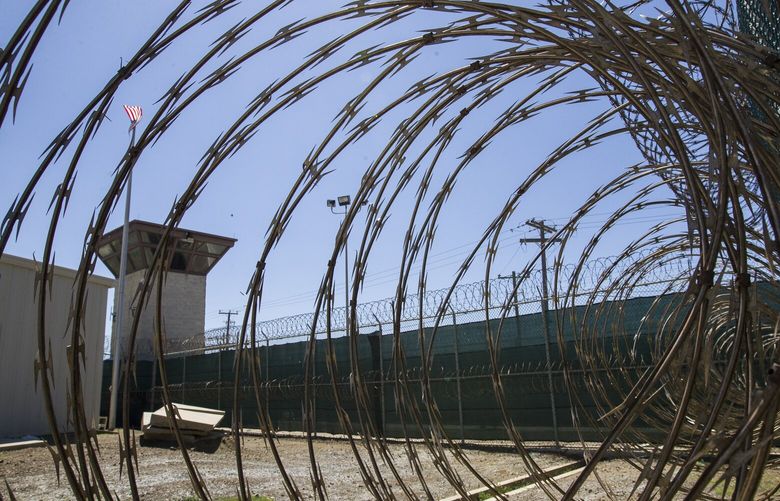 FILE – In this April 17, 2019, photo, reviewed by U.S. military officials, the control tower is seen through the razor wire inside the Camp VI detention facility in Guantanamo Bay Naval Base, Cuba. A military medical panel has concluded that one of the five 9/11 defendants held at Guantanamo Bay has been rendered delusional and psychotic by the torture he underwent years ago while in CIA custody.  A military judge is expected to rule as soon as Thursday whether al-Shibh’s mental issues render him incompetent to take part in the proceedings against him. (AP Photo/Alex Brandon, File) WX106 WX106