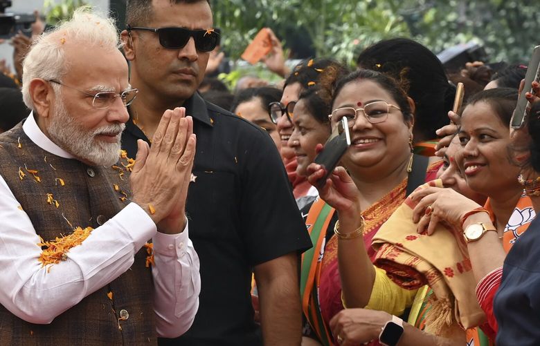 Indian Prime Minister Narendra Modi is welcomed at the Bharatiya Janata Party headquarters, where he was felicitated a day after the women’s reservation bill was passed by the Indian Parliament in New Delhi, Friday, Sep. 22, 2023. (AP Photo/STR) STR101 STR101