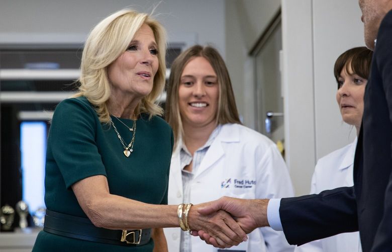 First Lady of the United States Jill Biden shakes hand with Dr. Cyrus Ghajar, public health researcher, as she visits and tours a lab at Fred Hutchinson Cancer Center Friday, Sept. 22, 2023. As part of the Biden Administration’s Cancer Moonshot, Biden highlights the importance of supporting cancer survivors through specialized care and research, including survivors of childhood cancers and breast cancer.