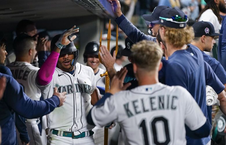 Seattle Mariners’ Julio Rodriguez celebrates with a trident in the dugout after hitting a home run during a baseball game against the Los Angeles Angels, Monday, Sept. 11, 2023, in Seattle. (AP Photo/Lindsey Wasson) OTK OTK