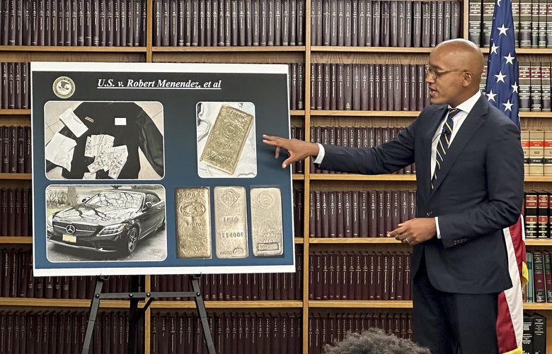 Damian Williams, U.S. Attorney for the Southern District of New York, talks about a display of photos of evidence in an indictment against Sen. Bob Menendez, D-N.J., during a news conference, Friday, Sept. 22, 2023, in New York. The sweeping bribery case brought against Menendez includes allegations that he took cash and gold in exchange for interfering in a criminal case against a New Jersey real estate developer.(AP Photo/Robert Bumsted) WX202 WX202