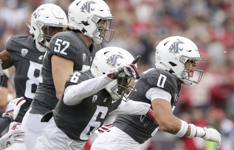 Washington State defensive back Sam Lockett III (0) celebrates intercepting an Oregon State pass with teammates during the first half of an NCAA college football game, Saturday, Sept. 23, 2023, in Pullman, Wash. (AP Photo/Young Kwak) WAYK110 WAYK110