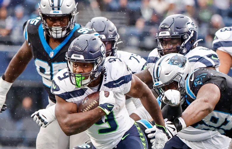 Kenneth Walker III bounces off tacklers and rushes for 10-yards to the Panther 17-yard line in the fourth quarter, setting up the Seahawks’ final touchdown.  The Carolina Panthers played the Seattle Seahawks in NFL Football Sunday, Sept. 24, 2023, at Lumen Field in Seattle, WA. 225064