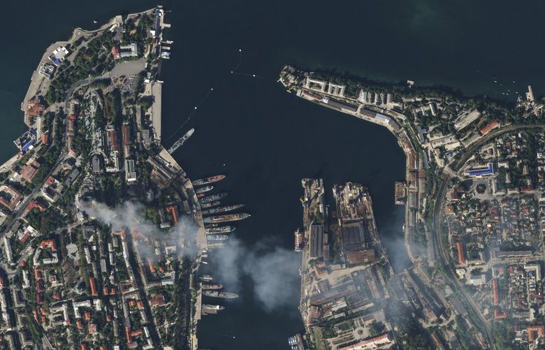 In this satellite photo provided by Planet Labs, smoke billows from a headquarters building for the Russian Black Sea fleet in Sevastopol, Crimea on Friday, Sept. 22, 2023, after it was struck in a missile attack launched by the Ukrainian military. (Planet Labs via AP) NY696 NY696