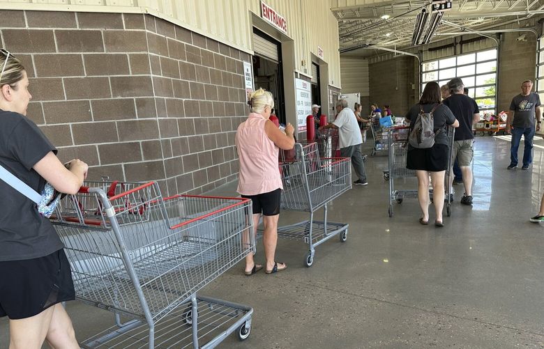 Shoppers queue up to enter a Costco warehouse Friday, Aug. 4, 2023, in Thornton, Colo. (AP Photo/David Zalubowski) OTKDZ105