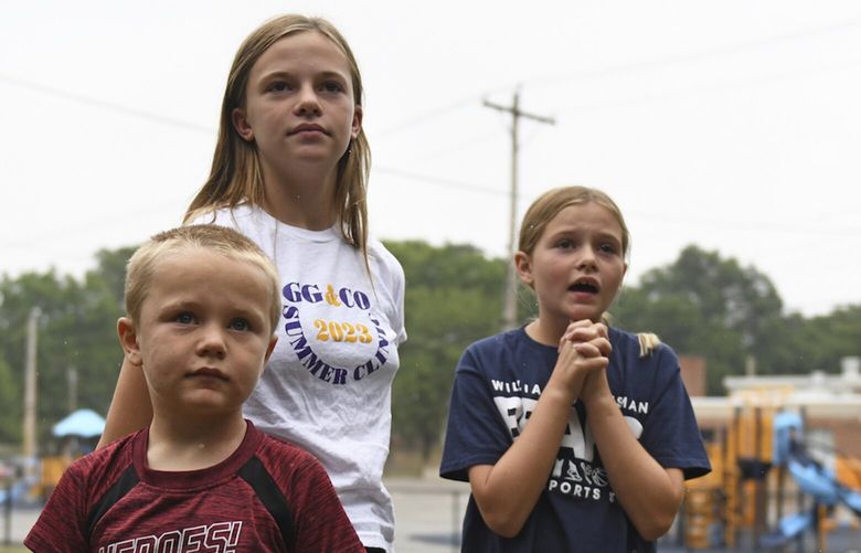 Hudson, 7, left, Callahan, 13, middle, and Keegan Pruente, 10, right, stand outside their school on their first Monday home during the new four-day school week on Monday, Sept. 11, 2023, in Independence, Mo. Hundreds of school systems around the country have adopted four-day weeks in recent years, mostly in rural and western parts of the U.S. Districts cite cost savings and advantages for teacher recruitment. Still, some experts question the effects on students who already missed out on significant learning during the pandemic.  (AP Photo/Nick Ingram) XNI101 XNI101