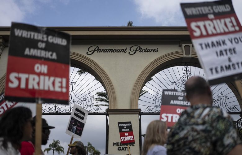 FILE – Demonstrators walk with signs during a rally outside the Paramount Pictures Studio in Los Angeles, Thursday, Sept. 21, 2023. A tentative deal was reached, Sunday, Sept. 24, 2023, to end Hollywood’s writers strike after nearly five months. (AP Photo/Jae C. Hong, File) GAAK603 GAAK603