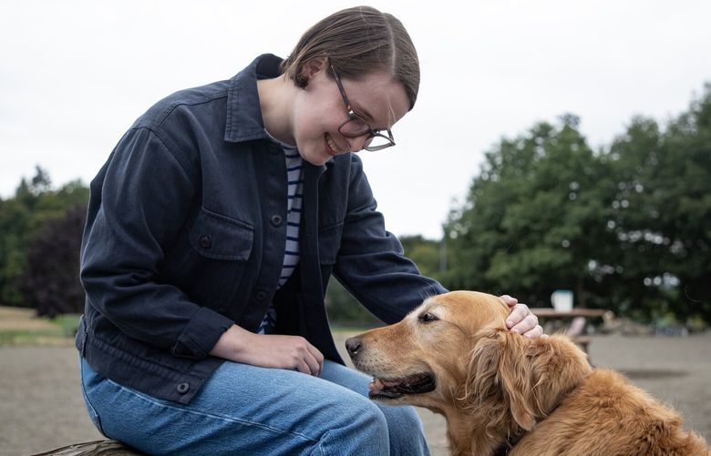 Local author Susanna Ryan meets 8-year-old golden retriever, Luna Tuesday, Sept. 12, 2023, in Seattle. Ryan’s new book, “Dog Days: Your Furbaby Memory Book,” is publishing in the coming weeks.
