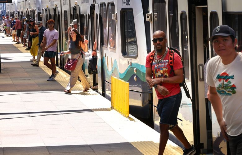People get off Sound Transit Light Rail trains at Stadium Station in Seattle on Wednesday, August 2, 2023.