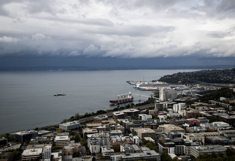 Storm clouds roll across the Elliott Bay Tuesday, Sept. 26, 2023, as seen from the roof of the Space Needle in Seattle.
 (Luke Johnson / The Seattle Times)