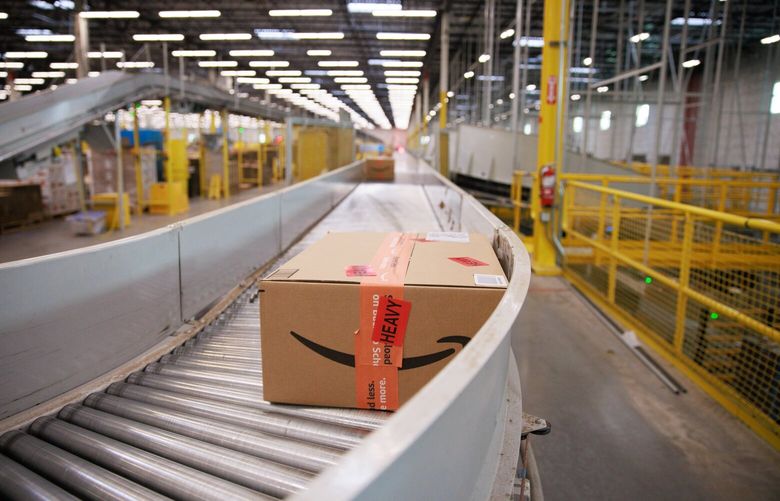 Packages travel on conveyor belts inside Amazon’s Kent fulfillment center Friday, July 22, 2022. 221047 221047