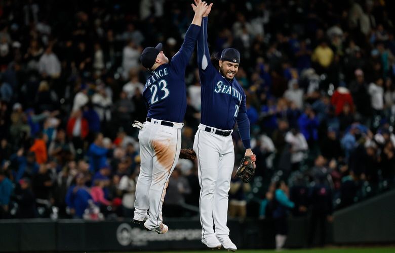 Seattle Mariners first baseman Ty France high-fives third baseman Eugenio Suarez after a 6-2 win over the Houston Astros Tuesday, Sept. 26, 2023 in Seattle. 225047