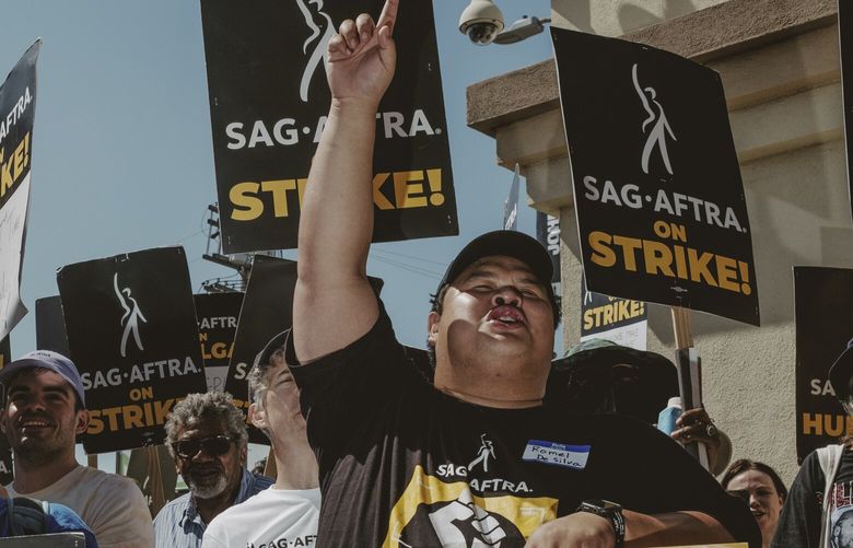 Members of SAG-AFTRA, which represents actors and remains on strike, pickets in front of Paramount Pictures in Los Angeles, on Sept. 26, 2023. After 148 days on strike, television and movie writers will begin returning to work on Wednesday, Sept. 27, 2023. (Mark Abramson/The New York Times) XNYT0177 XNYT0177
